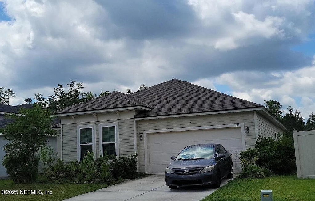855 Sycamore Way, Orange Park, FL 32073 - view of front of home featuring concrete driveway, an attached garage, and a shingled roof