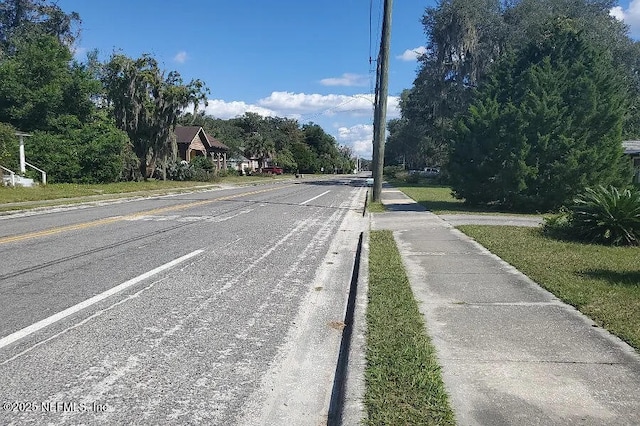 21813 SE 69th Ave, Hawthorne, FL 32640 - view of asphalt road featuring sidewalks and curbs