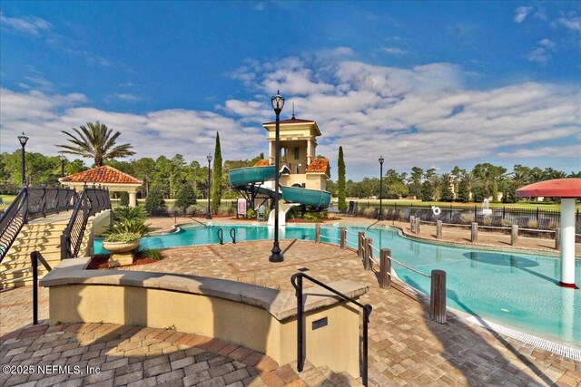 2144 S Sorrento Hills Rd, Saint Augustine, FL 32092 - community pool featuring a water slide and a patio area
