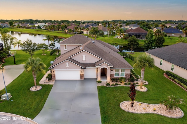 2144 S Sorrento Hills Rd, Saint Augustine, FL 32092 - view of front of property featuring a water view, stone siding, a residential view, driveway, and a garage