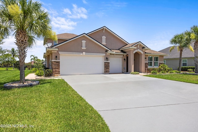 2144 S Sorrento Hills Rd, Saint Augustine, FL 32092 - view of front facade with stucco siding, an attached garage, concrete driveway, a front yard, and stone siding