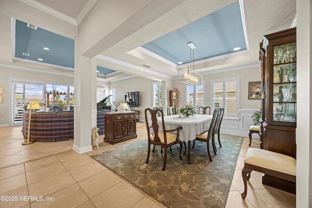 2144 S Sorrento Hills Rd, Saint Augustine, FL 32092 - dining area with a raised ceiling, crown molding, plenty of natural light, light tile patterned flooring, and a chandelier