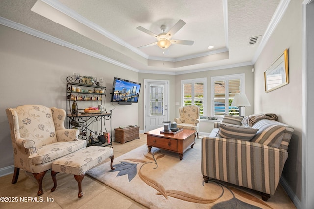 2144 S Sorrento Hills Rd, Saint Augustine, FL 32092 - tiled living room featuring a tray ceiling, crown molding, a ceiling fan, and a textured ceiling