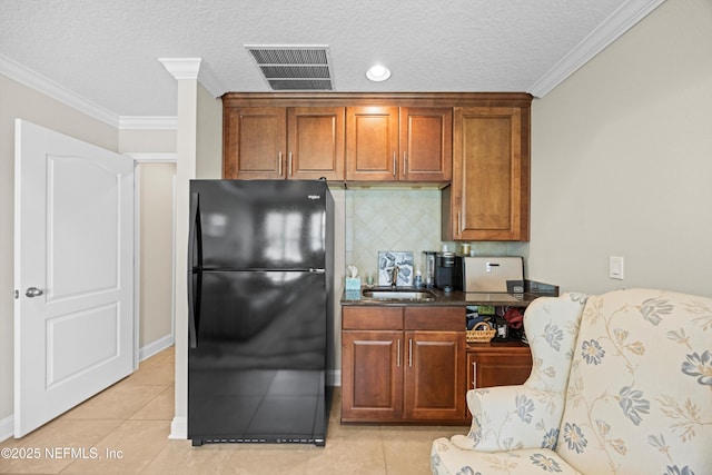 2144 S Sorrento Hills Rd, Saint Augustine, FL 32092 - kitchen featuring freestanding refrigerator, tasteful backsplash, ornamental molding, a textured ceiling, and light tile patterned floors