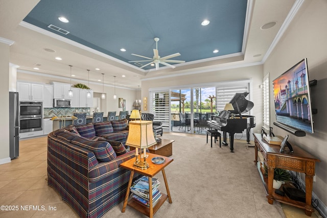 2144 S Sorrento Hills Rd, Saint Augustine, FL 32092 - living room featuring a raised ceiling, crown molding, ceiling fan, recessed lighting, and light colored carpet