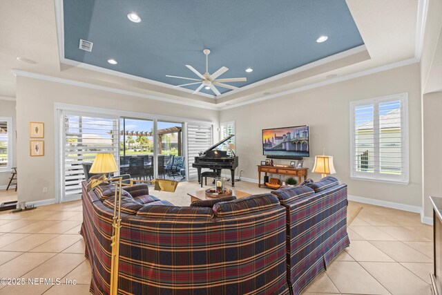 2144 S Sorrento Hills Rd, Saint Augustine, FL 32092 - living room featuring a tray ceiling, light tile patterned floors, ornamental molding, and recessed lighting