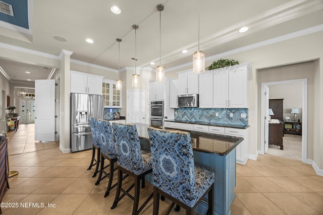 2144 S Sorrento Hills Rd, Saint Augustine, FL 32092 - kitchen featuring appliances with stainless steel finishes, light tile patterned flooring, backsplash, a breakfast bar area, and crown molding
