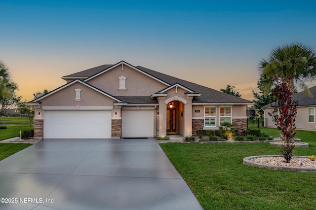 2144 S Sorrento Hills Rd, Saint Augustine, FL 32092 - view of front of home with stucco siding, stone siding, a yard, and concrete driveway