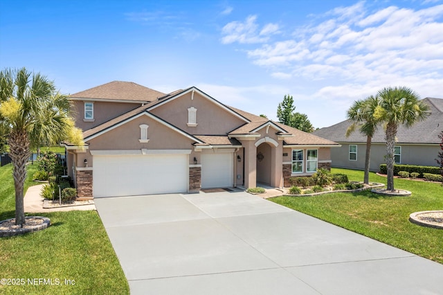 2144 S Sorrento Hills Rd, Saint Augustine, FL 32092 - view of front of house with stucco siding, an attached garage, a front lawn, concrete driveway, and stone siding
