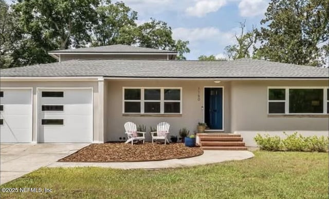 1160 Preston Pl, Jacksonville, FL 32207 - prairie-style home featuring an attached garage, a shingled roof, concrete driveway, and stucco siding