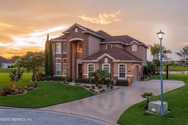 2148 S Sorrento Hills Rd, Saint Augustine, FL 32092 - view of front of house featuring stone siding, stucco siding, concrete driveway, and a lawn