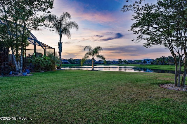 2148 S Sorrento Hills Rd, Saint Augustine, FL 32092 - yard at dusk with a water view, a yard, and glass enclosure