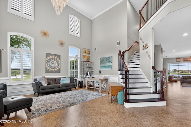 2148 S Sorrento Hills Rd, Saint Augustine, FL 32092 - tiled living room with a high ceiling, stairway, ornamental molding, and recessed lighting