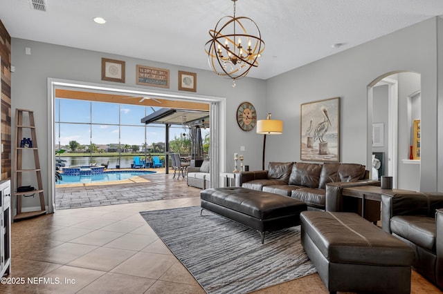 2148 S Sorrento Hills Rd, Saint Augustine, FL 32092 - tiled living room with a sunroom, arched walkways, a chandelier, and recessed lighting