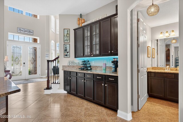 2148 S Sorrento Hills Rd, Saint Augustine, FL 32092 - bar with stairway, french doors, and a towering ceiling