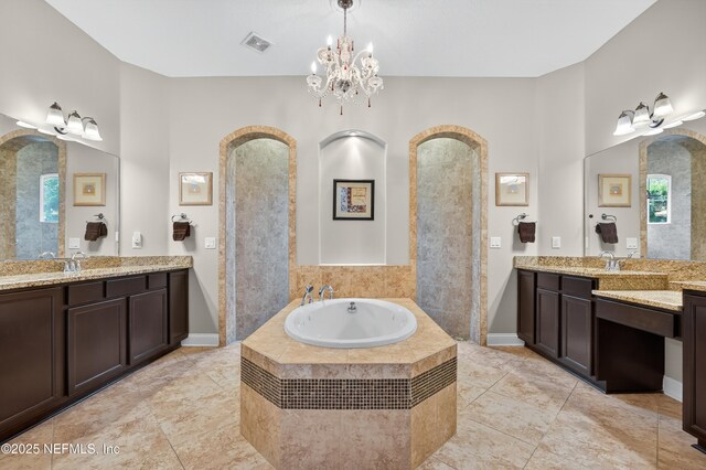 2148 S Sorrento Hills Rd, Saint Augustine, FL 32092 - full bathroom featuring a garden tub, two vanities, tile patterned flooring, and a chandelier