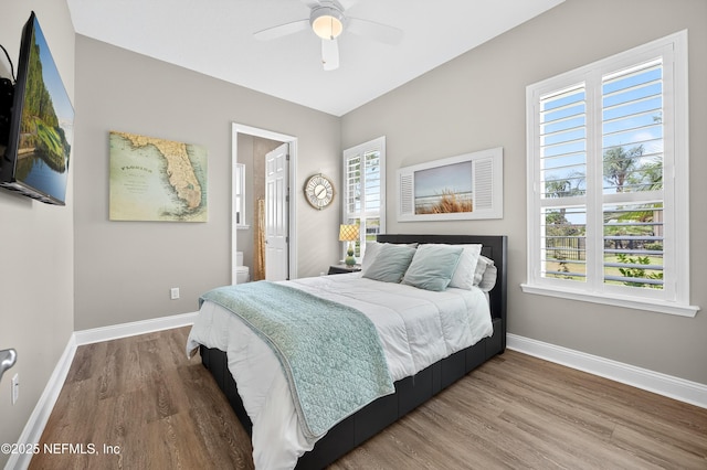2148 S Sorrento Hills Rd, Saint Augustine, FL 32092 - bedroom featuring wood finished floors, connected bathroom, and a ceiling fan