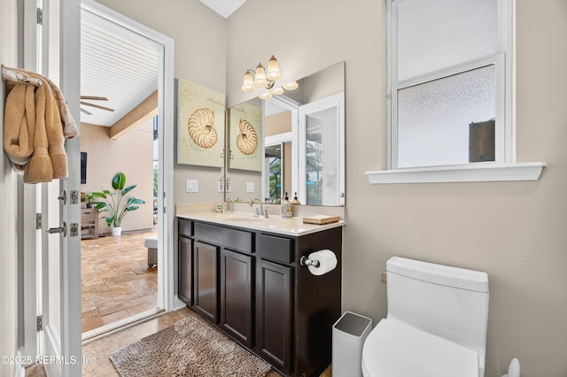 2148 S Sorrento Hills Rd, Saint Augustine, FL 32092 - bathroom featuring stone tile floors, vanity, and a ceiling fan