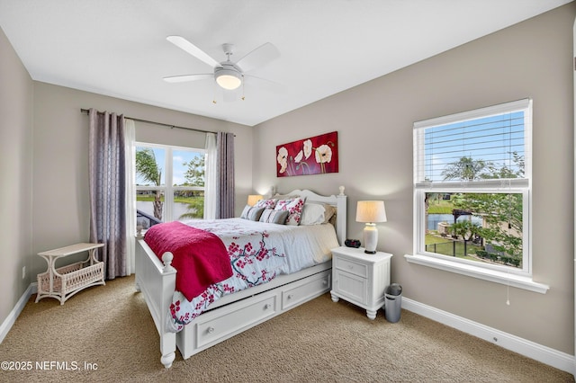 2148 S Sorrento Hills Rd, Saint Augustine, FL 32092 - bedroom with light colored carpet, a water view, and a ceiling fan