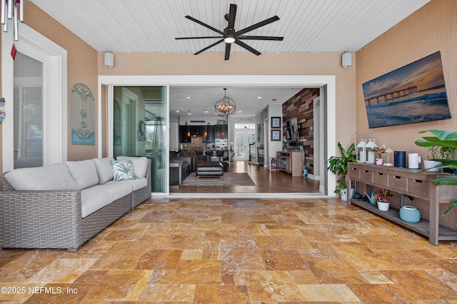 2148 S Sorrento Hills Rd, Saint Augustine, FL 32092 - living room with ceiling fan, a chandelier, and stone finish flooring