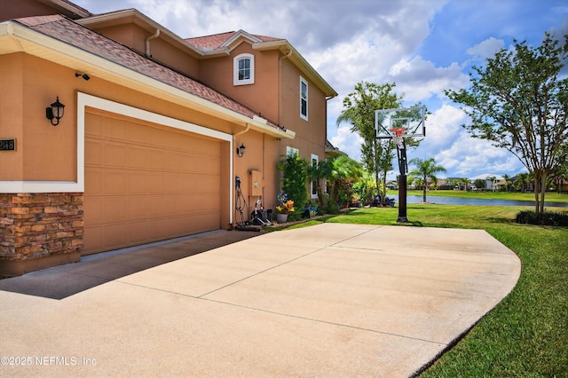 2148 S Sorrento Hills Rd, Saint Augustine, FL 32092 - view of side of home with a water view, stucco siding, a yard, and driveway
