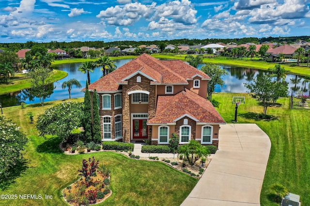2148 S Sorrento Hills Rd, Saint Augustine, FL 32092 - view of front of house with stone siding, a water view, and a front yard