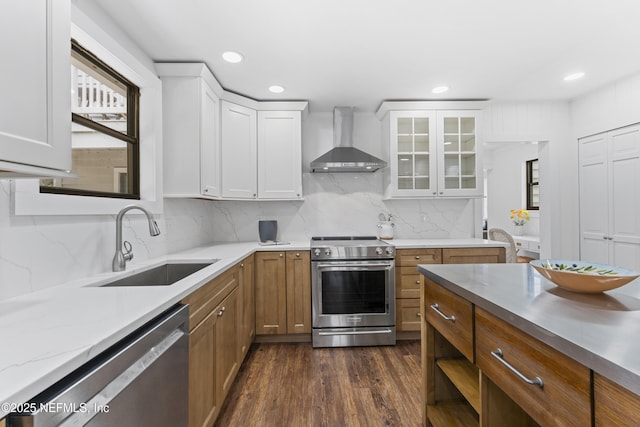 1381 Forrest Dr, Fernandina Beach, FL 32034 - kitchen with wall chimney range hood, appliances with stainless steel finishes, a sink, white cabinetry, and brown cabinetry