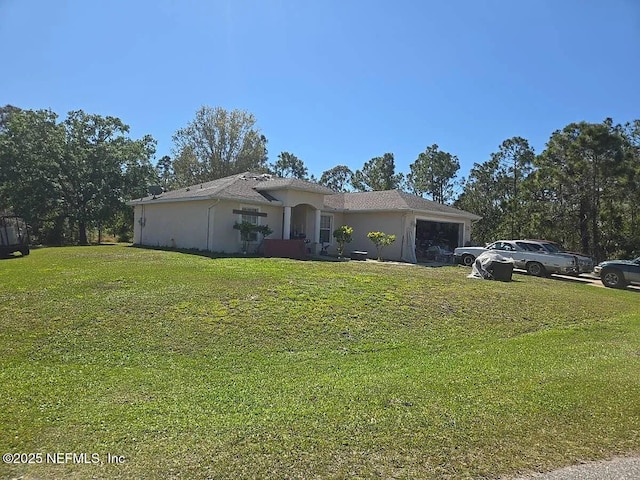 7811 Taplin Ave, North Port, FL 34291 - view of front facade featuring a garage, a front lawn, and stucco siding