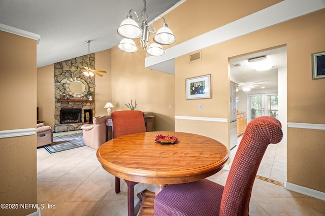 10571 Fox Squirrel Ct, Jacksonville, FL 32257 - dining space featuring ceiling fan, light tile patterned floors, a fireplace, and lofted ceiling