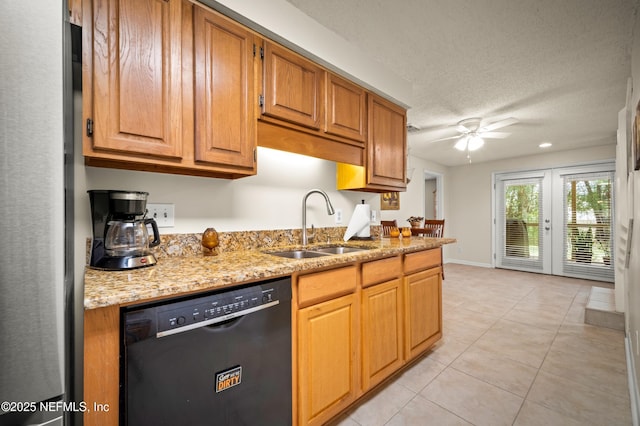 10571 Fox Squirrel Ct, Jacksonville, FL 32257 - kitchen featuring black dishwasher, light tile patterned floors, ceiling fan, light stone countertops, and freestanding refrigerator