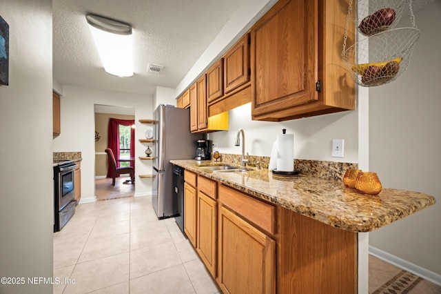 10571 Fox Squirrel Ct, Jacksonville, FL 32257 - kitchen featuring stainless steel range with electric cooktop, black dishwasher, brown cabinets, light stone countertops, and light tile patterned floors