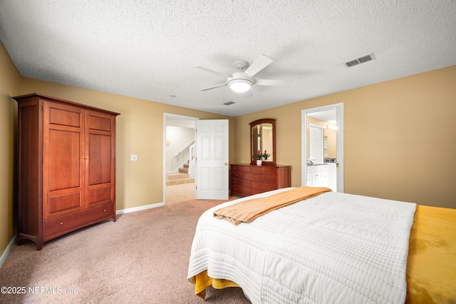 10571 Fox Squirrel Ct, Jacksonville, FL 32257 - bedroom with connected bathroom, a textured ceiling, light colored carpet, and a ceiling fan