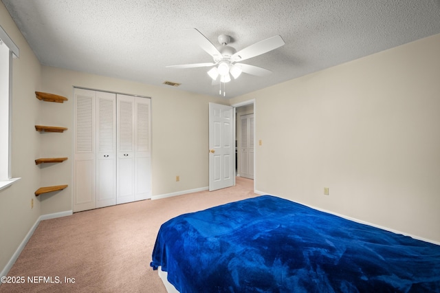 10571 Fox Squirrel Ct, Jacksonville, FL 32257 - bedroom featuring light carpet, a textured ceiling, a closet, and a ceiling fan