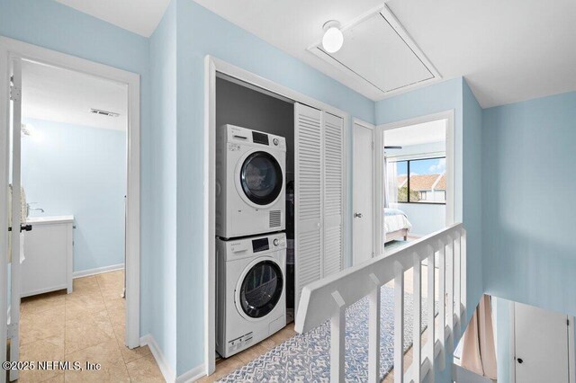 3145 Coastal Hwy Unit 1162, Saint Augustine, FL 32084 - laundry room with stacked washer / drying machine, attic access, baseboards, and light tile patterned flooring
