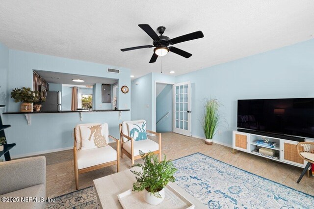 3145 Coastal Hwy Unit 1162, Saint Augustine, FL 32084 - living room with a ceiling fan, baseboards, a textured ceiling, and french doors
