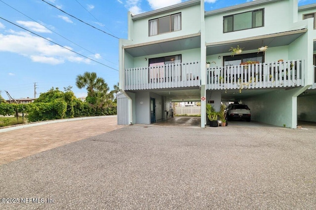 3145 Coastal Hwy Unit 1162, Saint Augustine, FL 32084 - view of front of home with a carport, stucco siding, and asphalt driveway