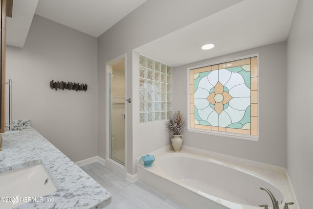 1766 Buttonbush Way, Fleming Island, FL 32003 - bathroom featuring a garden tub, double vanity, and a shower stall
