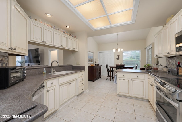 1766 Buttonbush Way, Fleming Island, FL 32003 - kitchen featuring stainless steel appliances, dark countertops, a chandelier, light tile patterned flooring, and recessed lighting