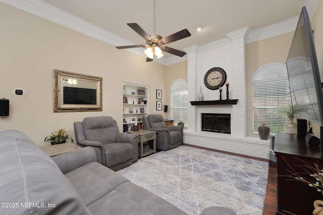 1766 Buttonbush Way, Fleming Island, FL 32003 - living room featuring ornamental molding, wood finished floors, a ceiling fan, a fireplace, and built in shelves