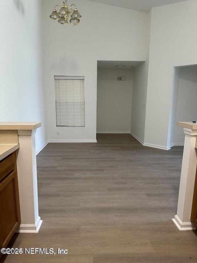 9625 Amarante Way Unit 12, Jacksonville, FL 32257 - unfurnished dining area featuring a chandelier, dark wood finished floors, and baseboards