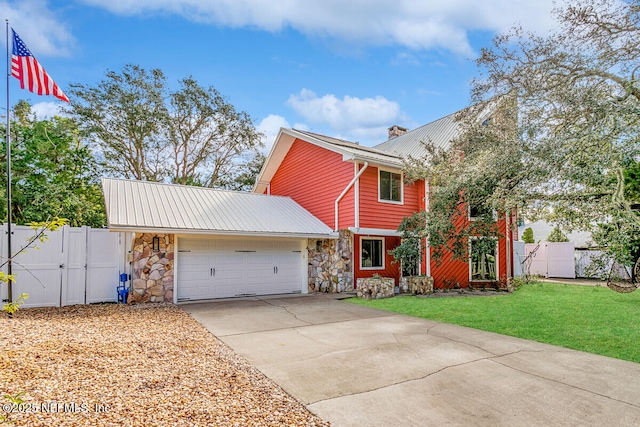 4 Santa Maria Ln, Saint Augustine, FL 32080 - view of front facade with stone siding, concrete driveway, a gate, a garage, and metal roof