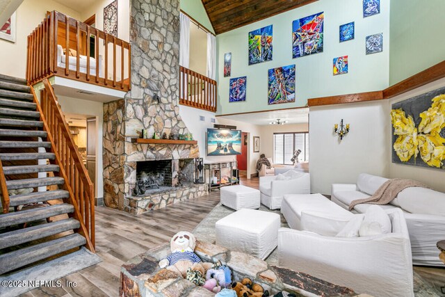4 Santa Maria Ln, Saint Augustine, FL 32080 - living room with wood finished floors, stairway, high vaulted ceiling, and a fireplace