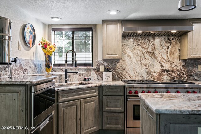4 Santa Maria Ln, Saint Augustine, FL 32080 - kitchen featuring stainless steel stove, a sink, exhaust hood, tasteful backsplash, and a textured ceiling