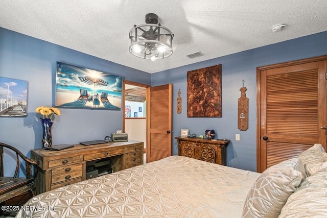 4 Santa Maria Ln, Saint Augustine, FL 32080 - bedroom with a textured ceiling, a closet, and a ceiling fan