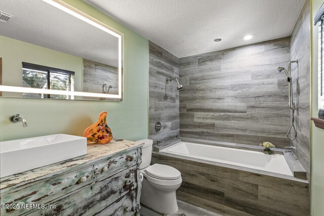 4 Santa Maria Ln, Saint Augustine, FL 32080 - full bathroom featuring toilet, vanity, a textured ceiling, and tiled shower / bath combo