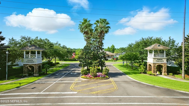 95362 Cornflower Dr, Fernandina Beach, FL 32034 - view of asphalt street featuring traffic signs, curbs, street lights, and sidewalks