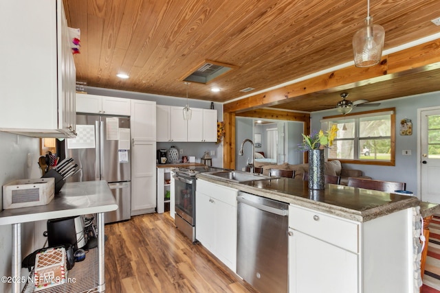 97150 Caravel Trl, Yulee, FL 32097 - kitchen featuring appliances with stainless steel finishes, wood ceiling, a sink, a peninsula, and light wood-style floors