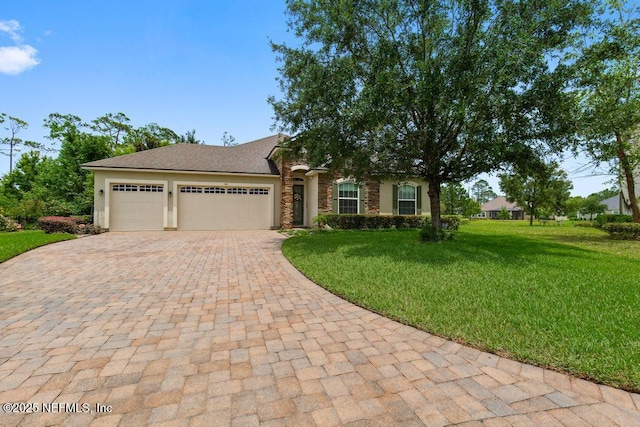 46 Gabacho Ct, Saint Augustine, FL 32095 - view of front of house with decorative driveway, a garage, a front yard, and stone siding