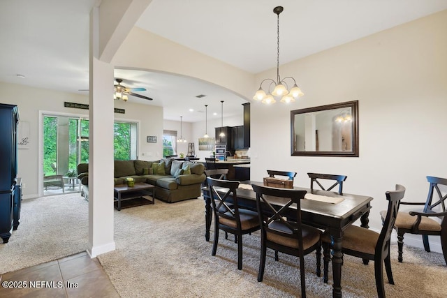 46 Gabacho Ct, Saint Augustine, FL 32095 - dining room with light carpet, a ceiling fan, arched walkways, light tile patterned flooring, and a chandelier