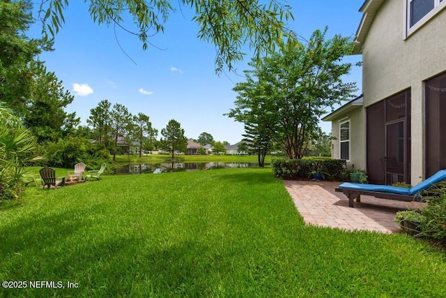 46 Gabacho Ct, Saint Augustine, FL 32095 - view of green lawn with a water view, an outdoor fire pit, and a patio area